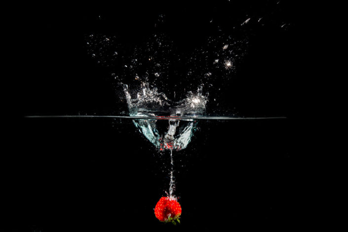 photo fraise qui tombe dans l'eau flash